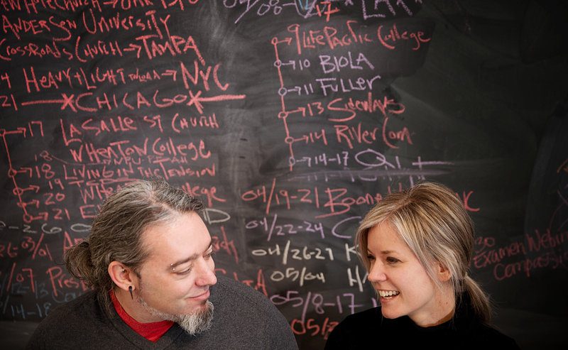 OMAHA, NEBRASKA - Chris and Phileena Heuertz sit in front of their chalk board filled with the years travels to spread the word about the Gravity Center, a nondenominational nonprofit devoted to helping people achieve doing good for other people on March 24th, 2013. BRYNN ANDERSON/THE WORLD-HERALD